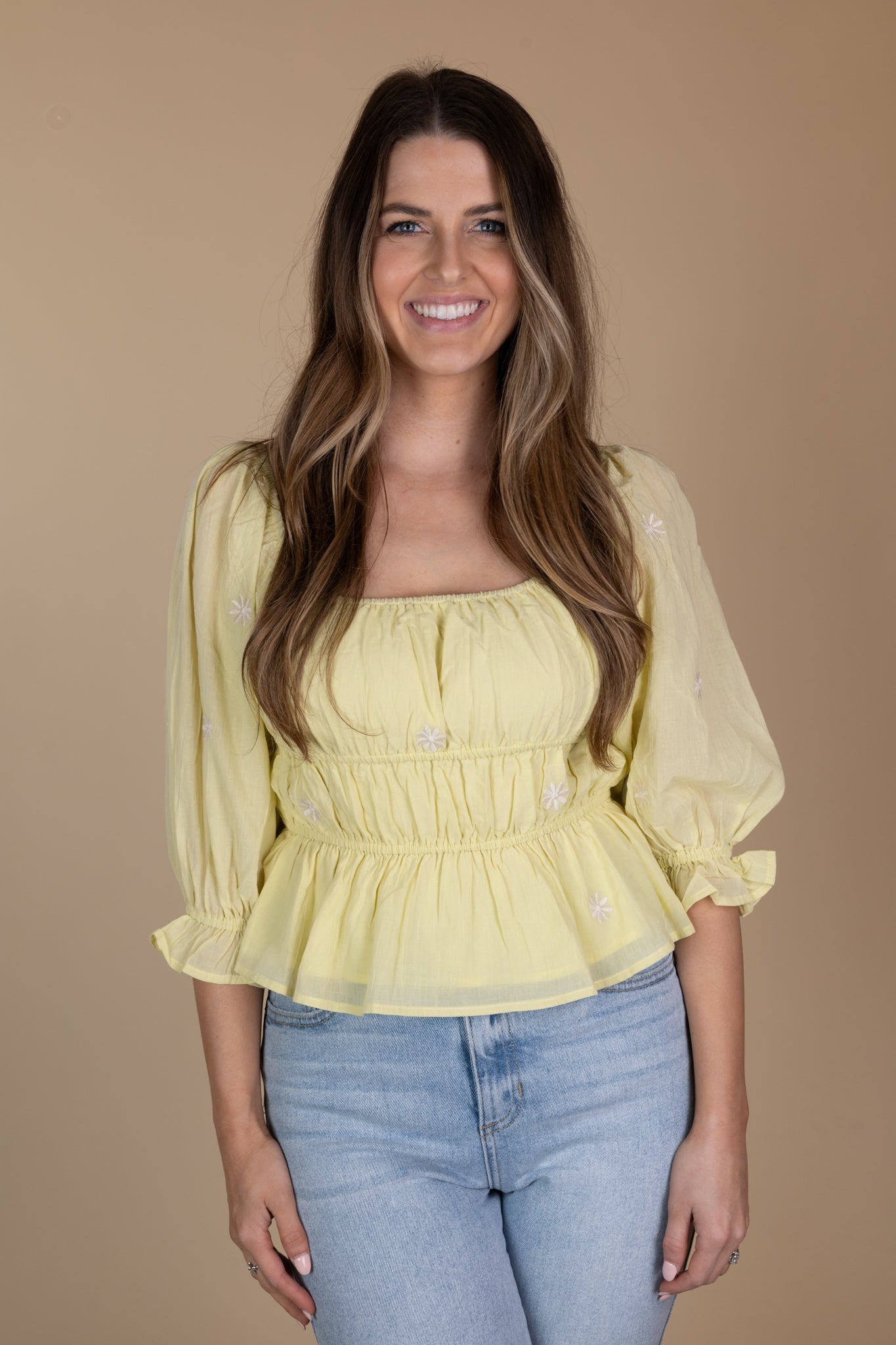 Front view of Lime green peplum blouse with embroidered floral details, three-quarter length puff sleeves, and a hip-length cut. Ideal for a sophisticated and elegant look.