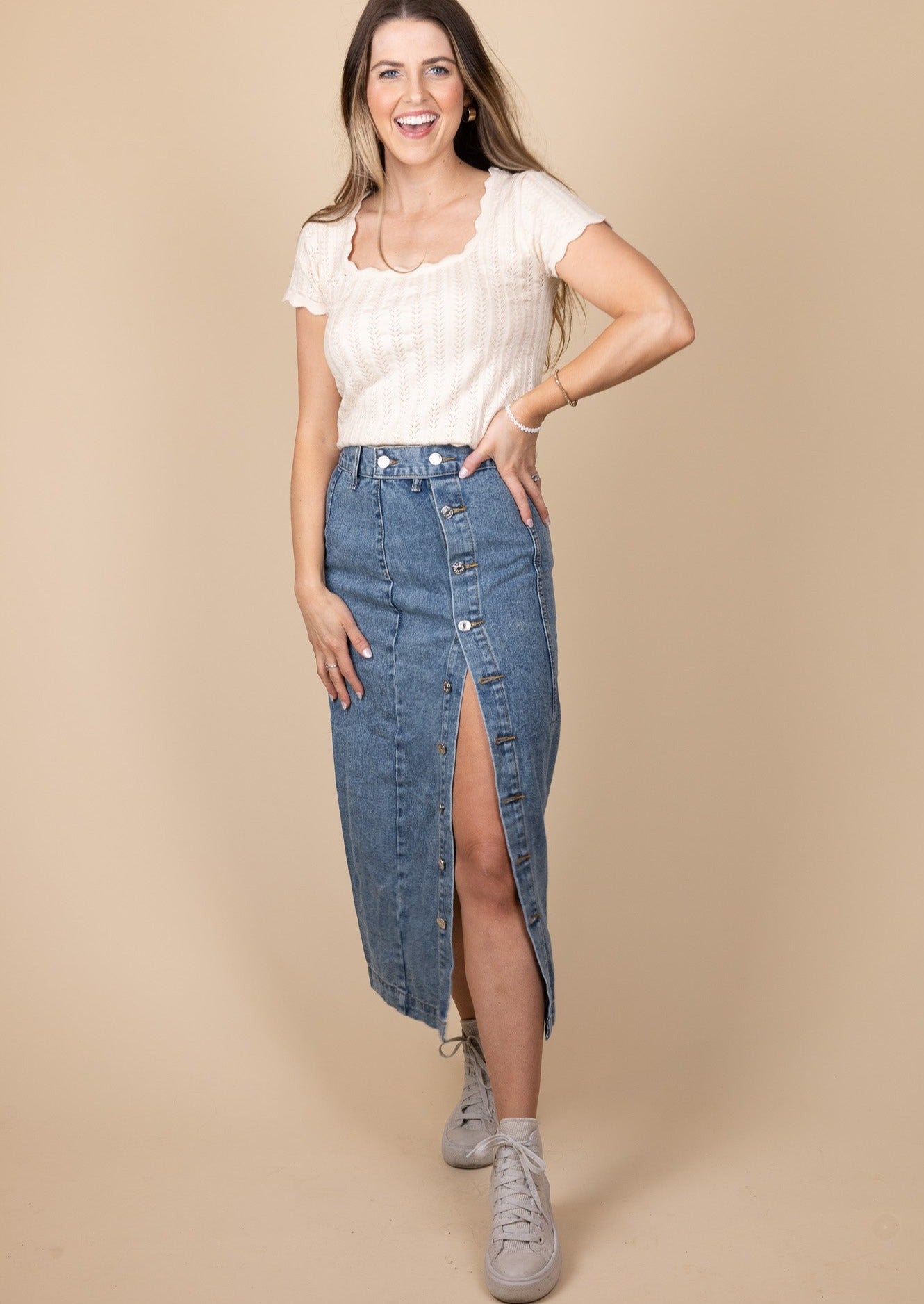 Side detail of Taylor Denim Midi Skirt in dark wash with button-down design, high-rise fit, and midi length, perfect for any occasion.