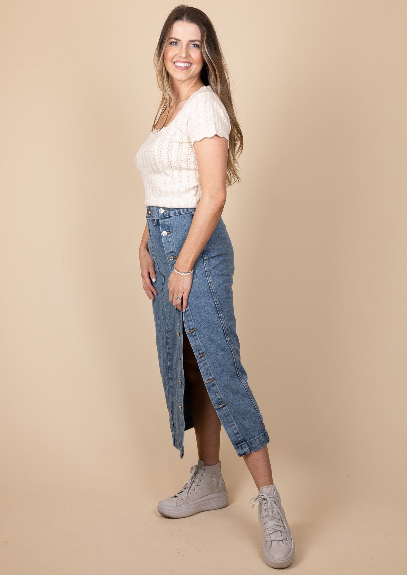 side view of Taylor Denim Midi Skirt in dark wash with button-down design, high-rise fit, and midi length, perfect for any occasion.