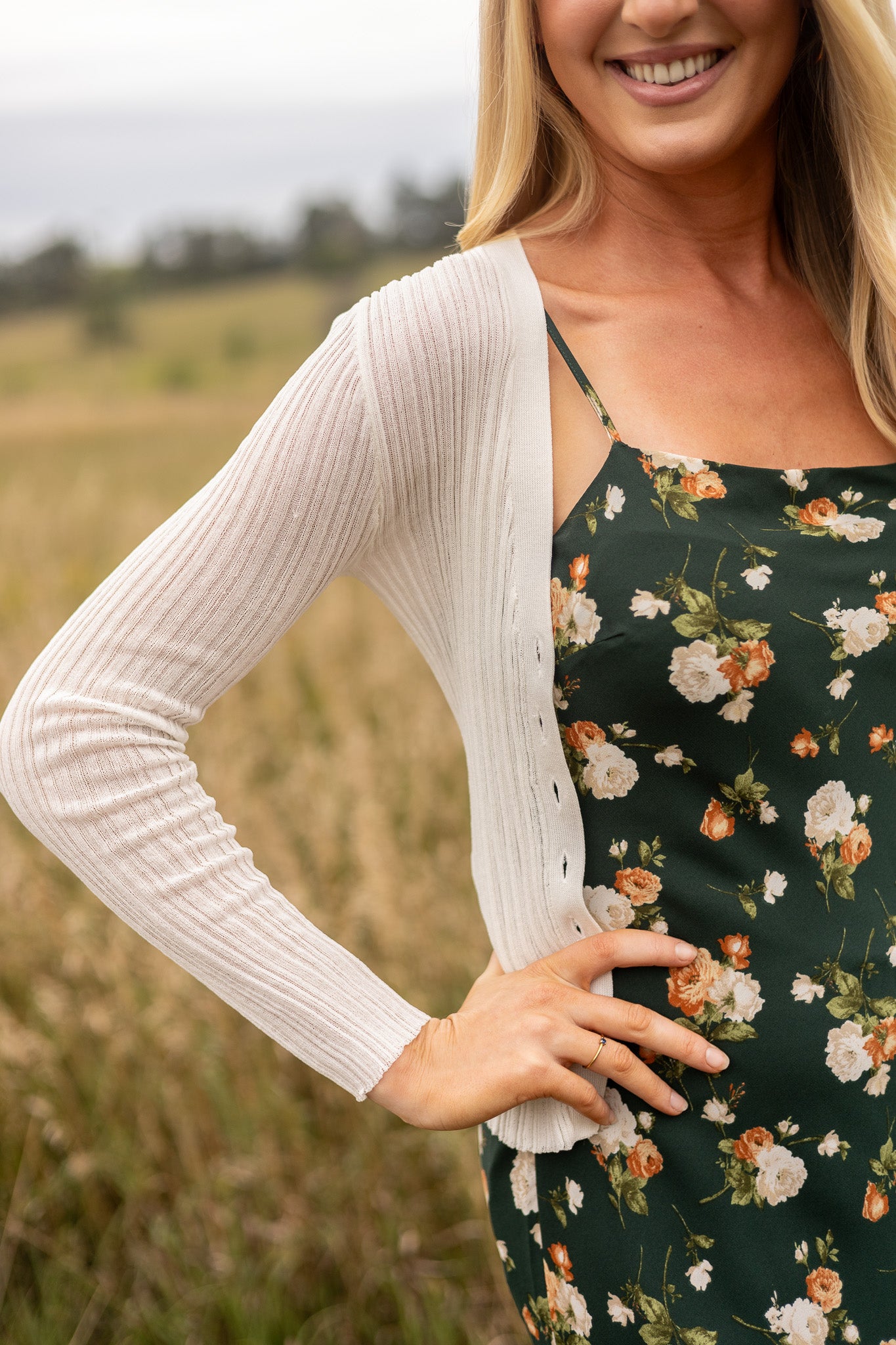 side view of light weight cream ribbed sweater paired with floral slip dress, great over thin straps
