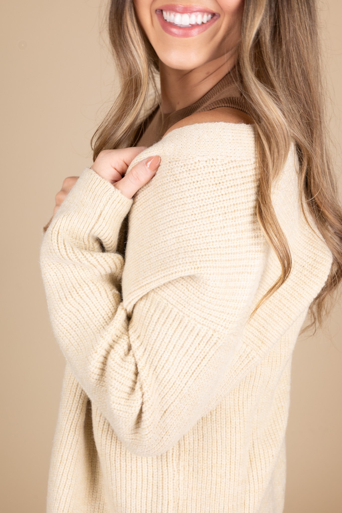 Everyday Oversized Cardigan in taupe color with cream and brown tortoise buttons. Side view of oversized comfy fit. Paired with brown high neck tank.