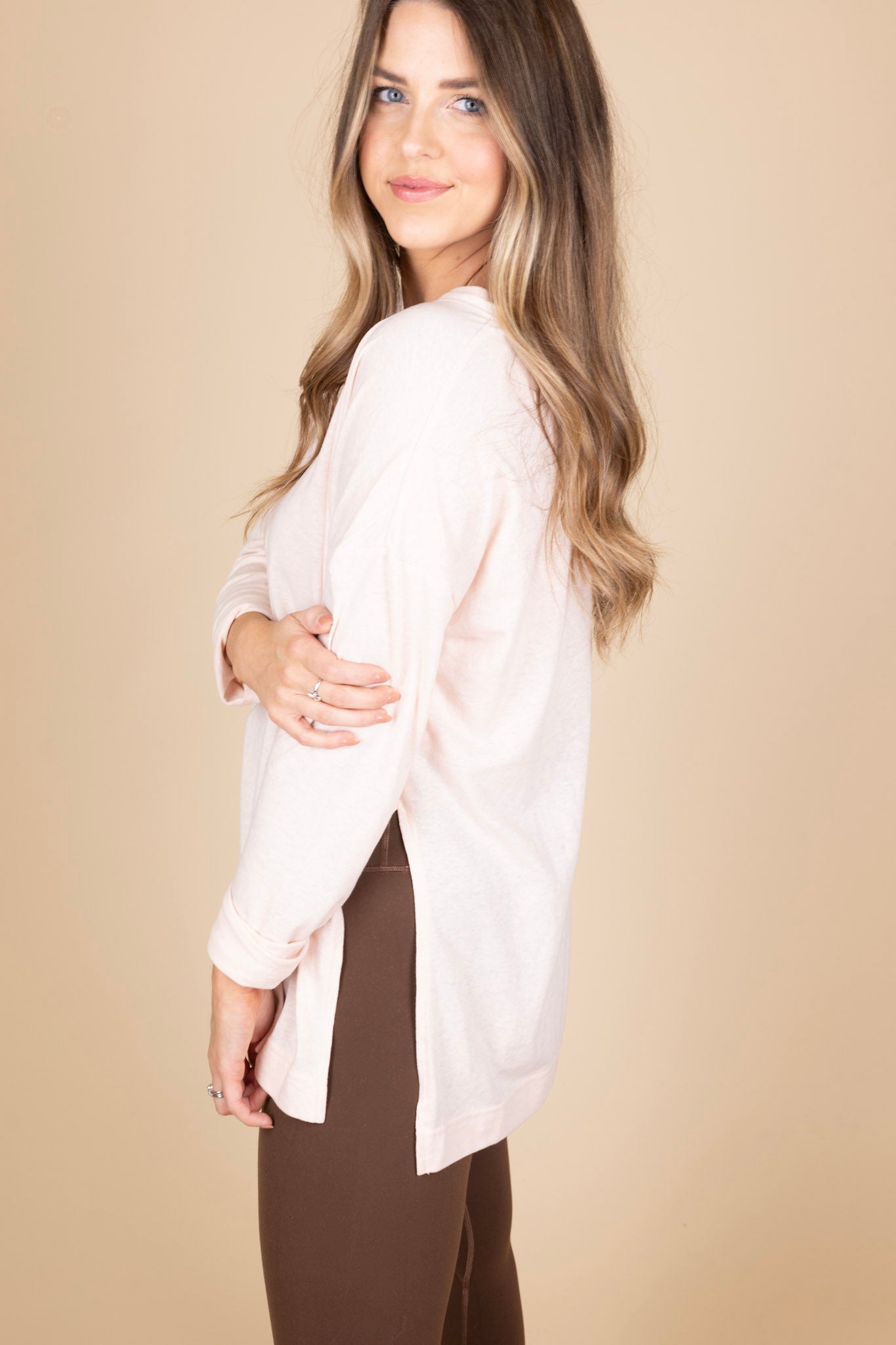 Perfect in Pink Tunic Top side view showing side slit and full length sleeves. Light weight and light pink heathered material. Paired with leggings.