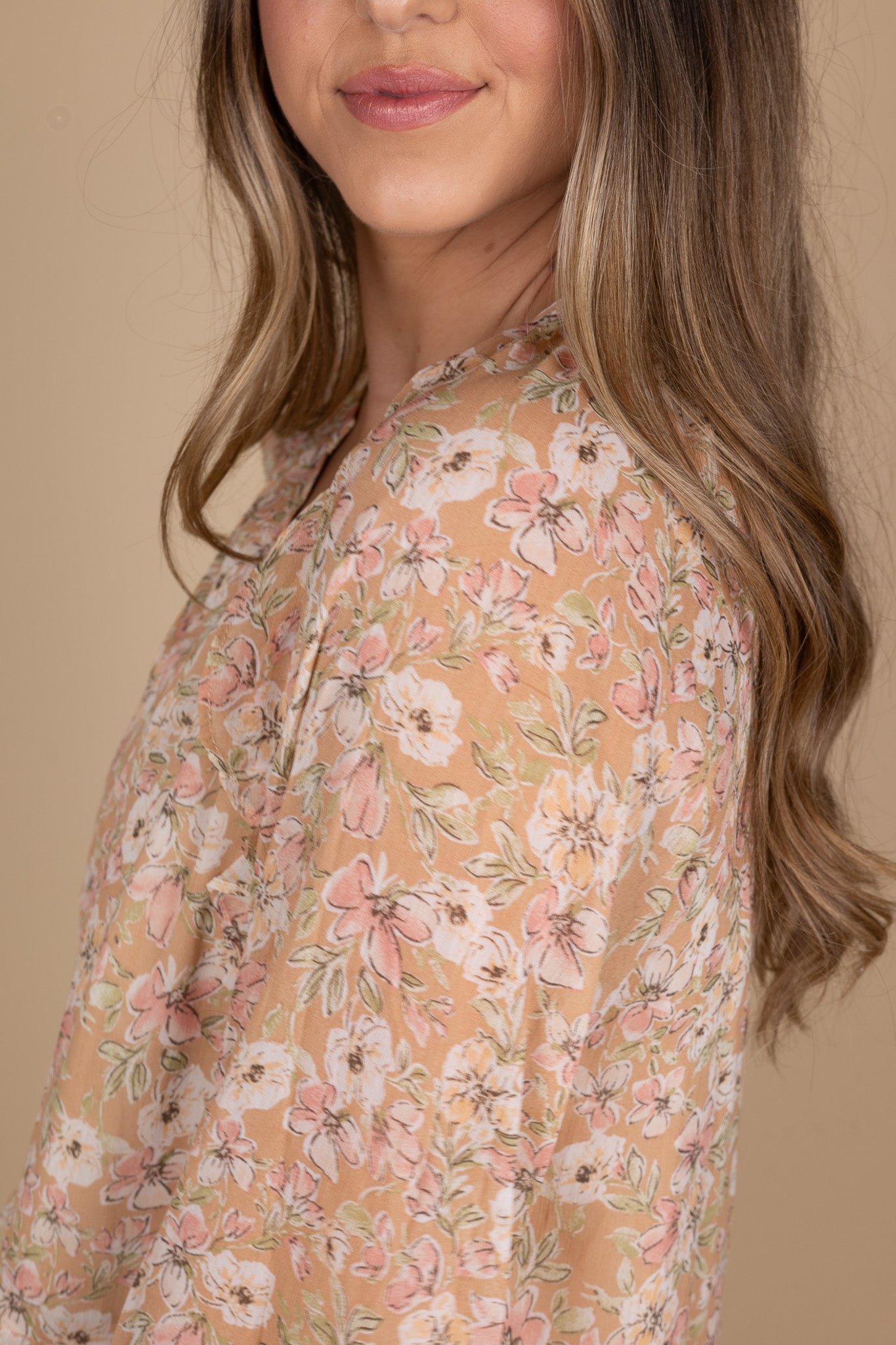 Finley Floral Buttoned Down Mini Dress close up view showing floral pattern with hints of pink and green coloring.