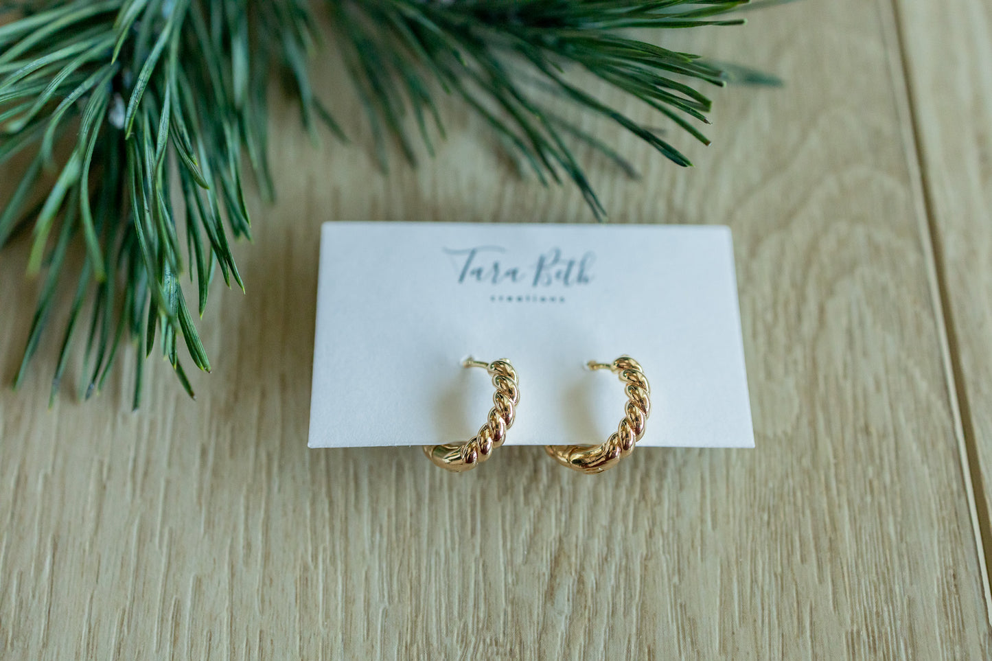 view of “Gold Twisted Hoops – elegant and lightweight hoop earrings with a modern twisted design for a timeless look.”