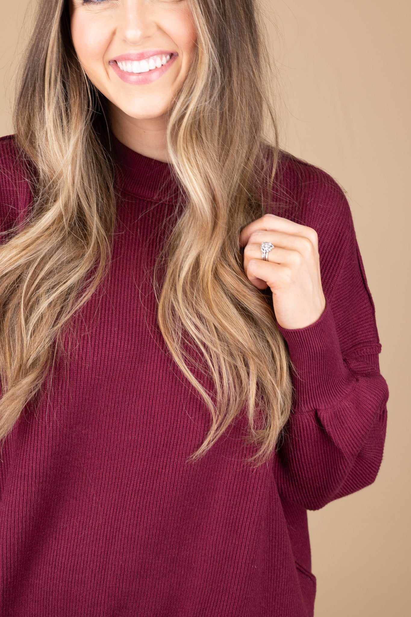 close up of sleeve hem view of “Cozy Crewneck Sweater in Wine Red – a soft, oversized knit sweater with a classic crewneck design for effortless style.”