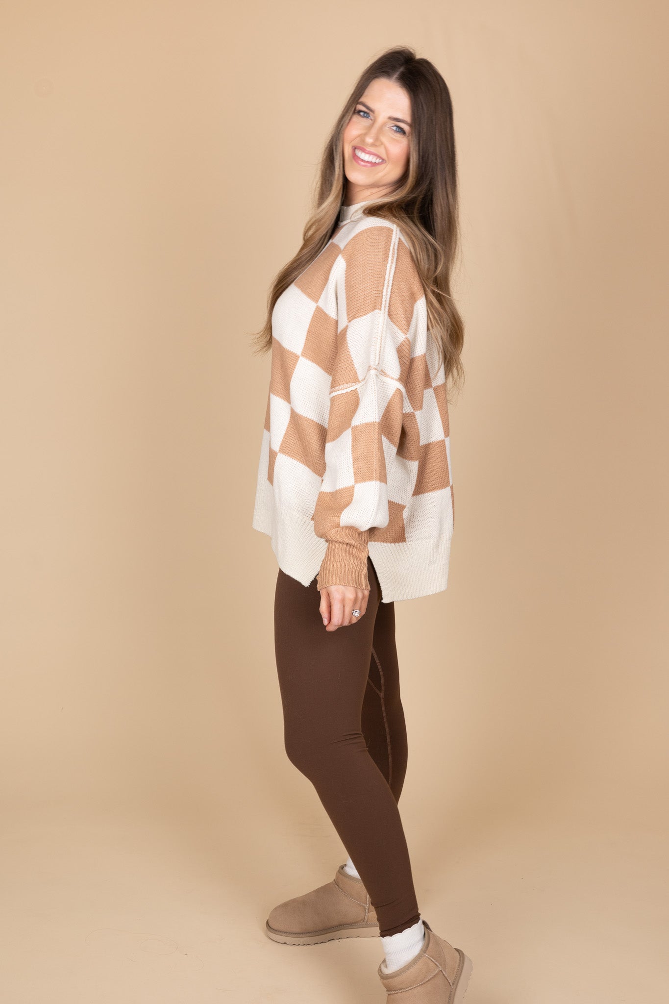 standing side view of “Cozy Checkered Crewneck Sweater – a soft knit sweater with a stylish checkered pattern and relaxed fit for effortless comfort.”