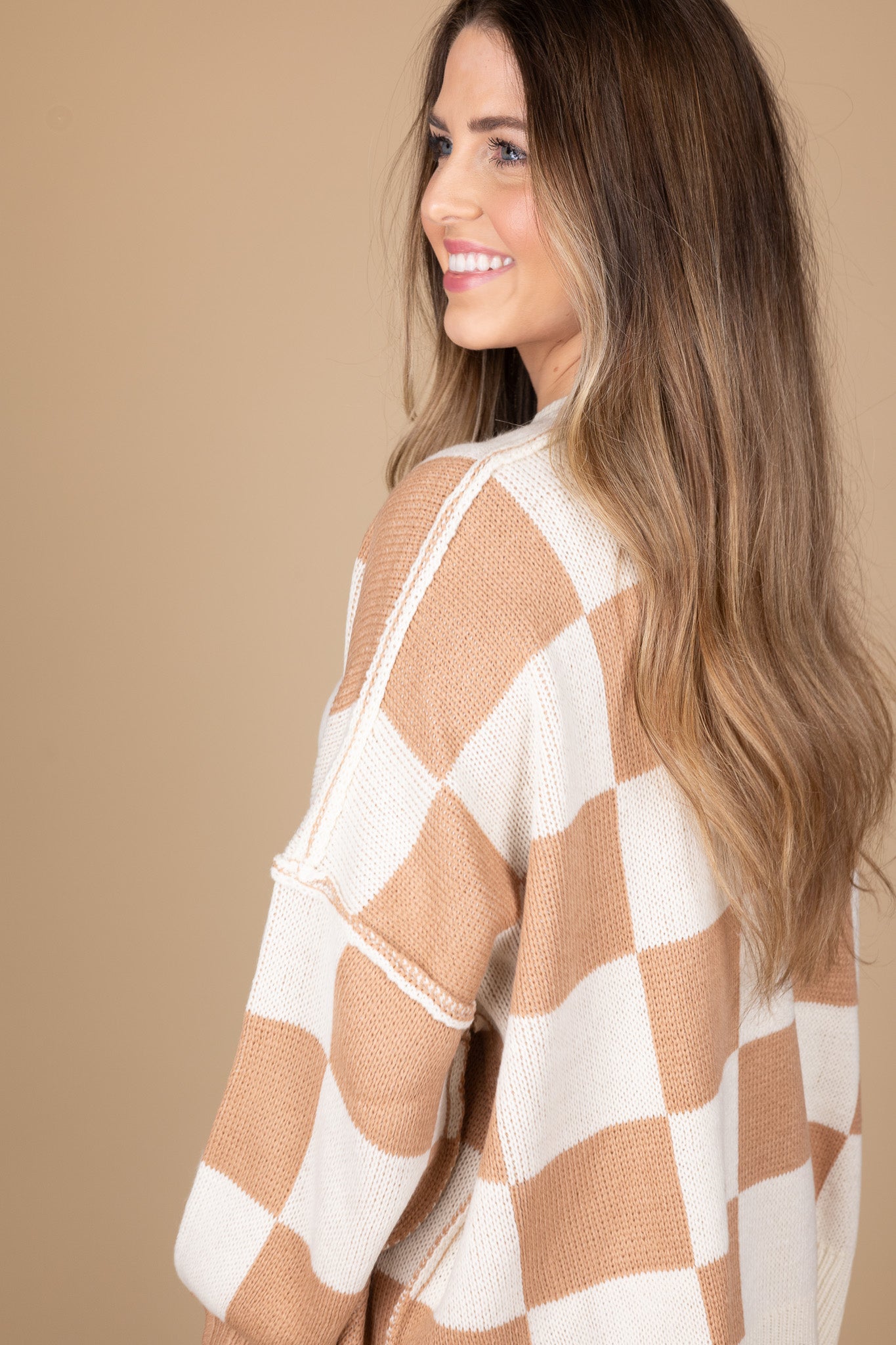 side view of “Cozy Checkered Crewneck Sweater – a soft knit sweater with a stylish checkered pattern and relaxed fit for effortless comfort.”