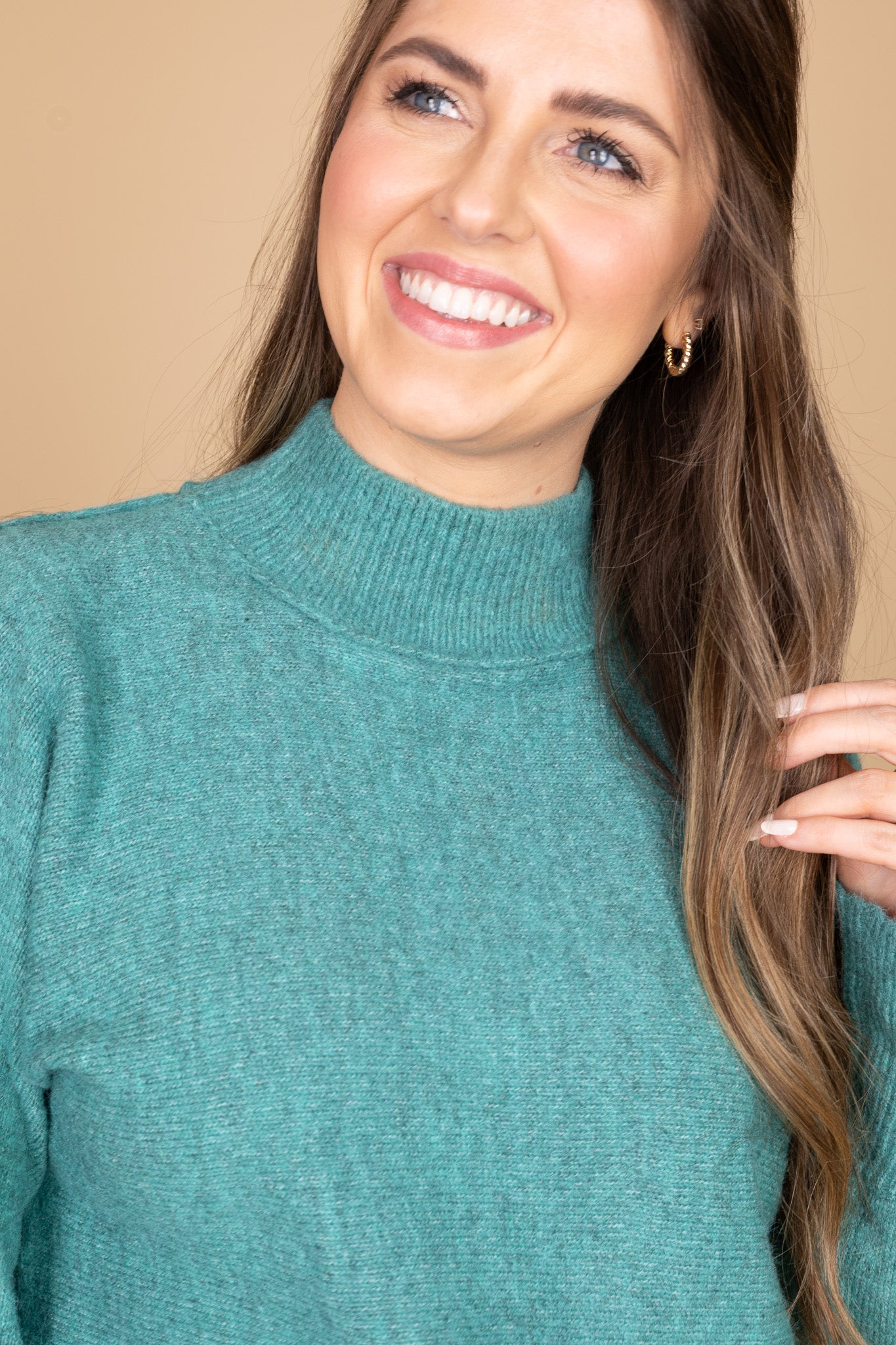 close up neck view of “Madeline Mock Neck Sweater – a soft ribbed knit sweater with a relaxed fit and elegant mock neckline.”