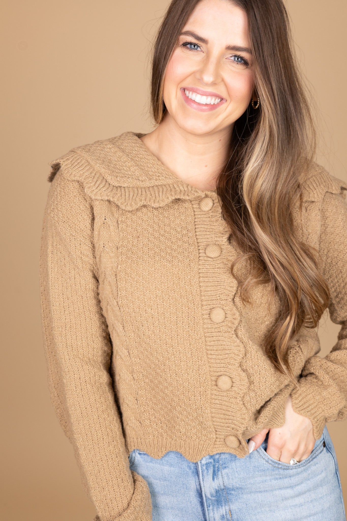 close up view of “Ava Scalloped Knit Cardigan – a soft and elegant knit cardigan with delicate scalloped edges for a feminine touch.”