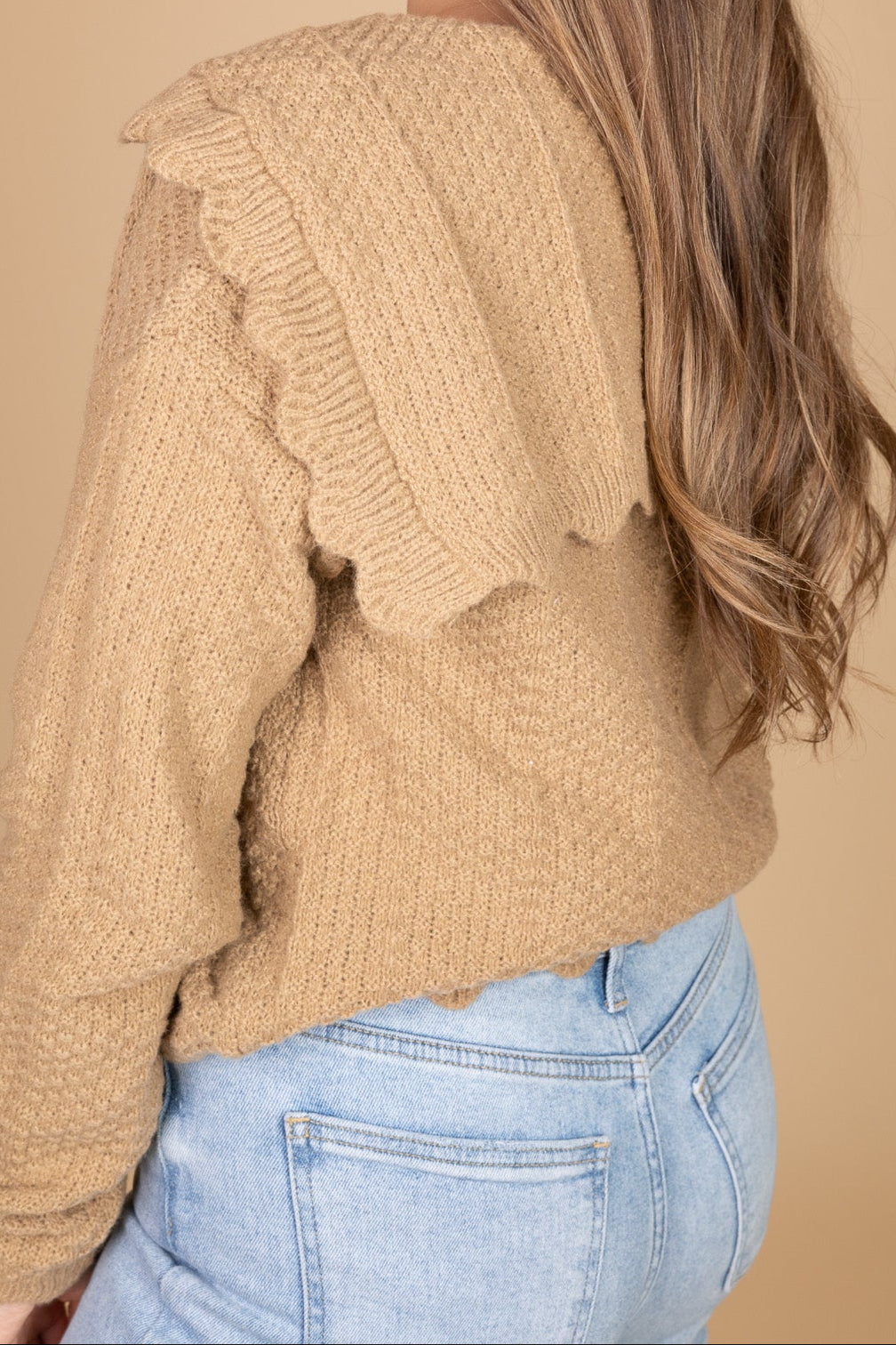 back shoulder view of “Ava Scalloped Knit Cardigan – a soft and elegant knit cardigan with delicate scalloped edges for a feminine touch.”