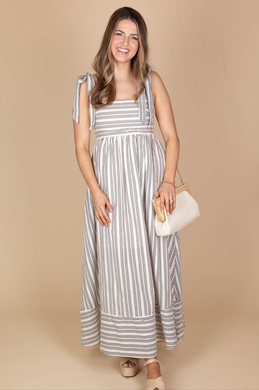 Linnley Linen Striped Maxi Dress with black and cream stitched stripe print, smocked backing, functional pockets, and bow tie straps