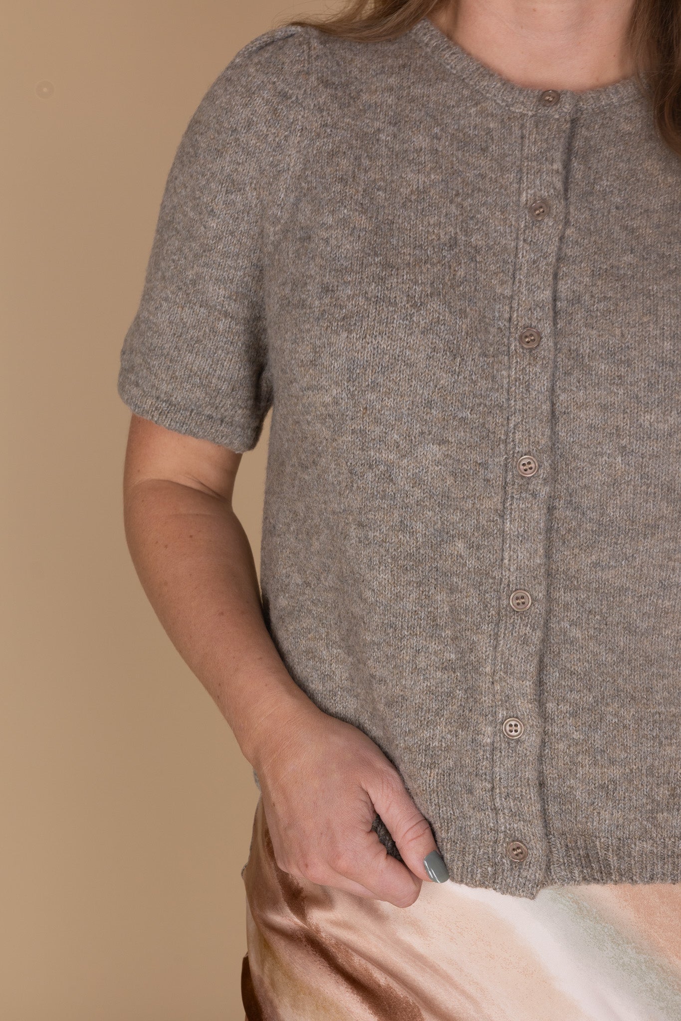 close up view of Heathered grey-brown puff sleeve cardigan with short sleeves and buttons — women’s neutral layering top