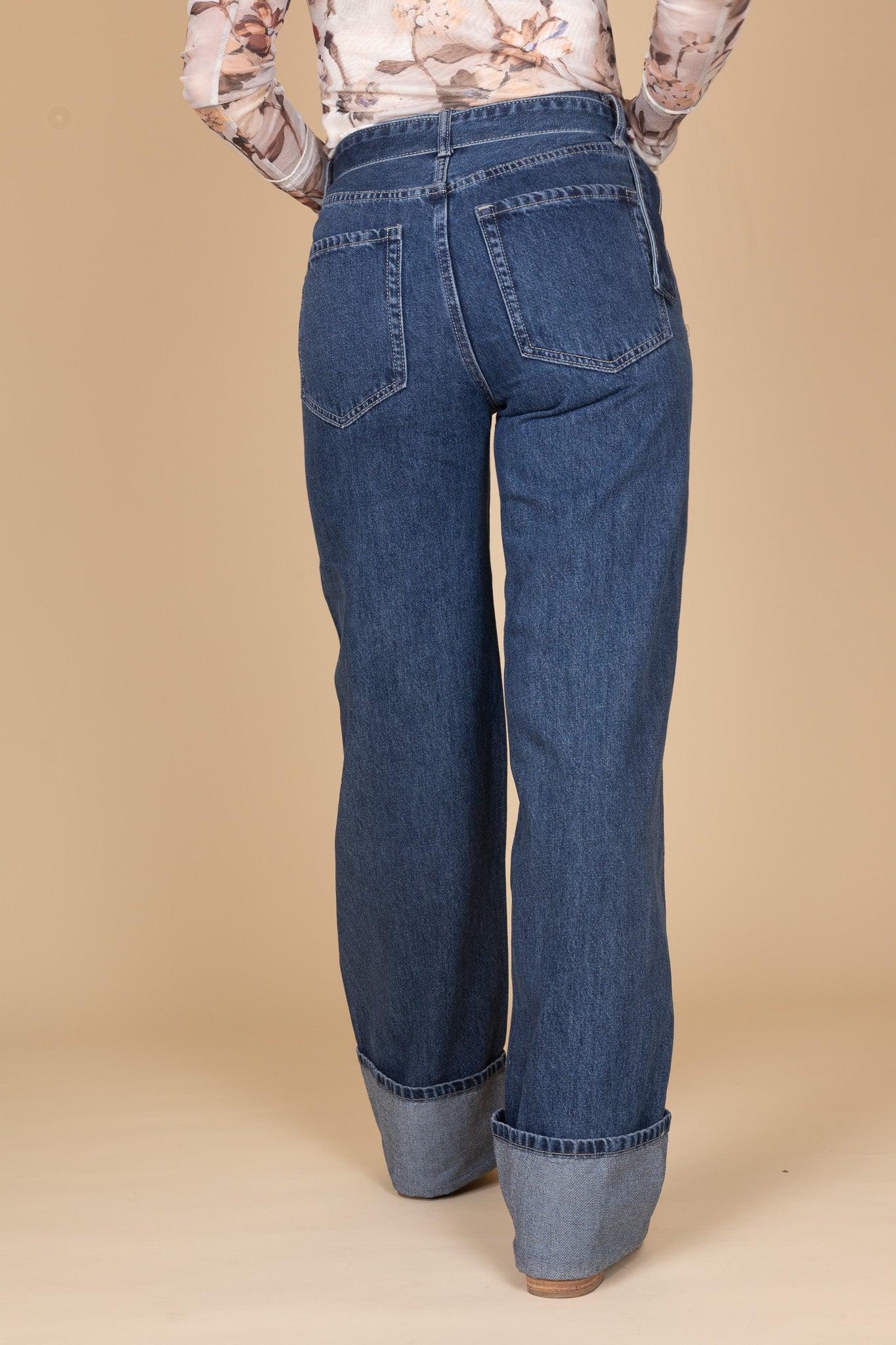 Wide leg cuffed denim jeans in dark wash with belt accent — classic women’s denim for everyday wear
