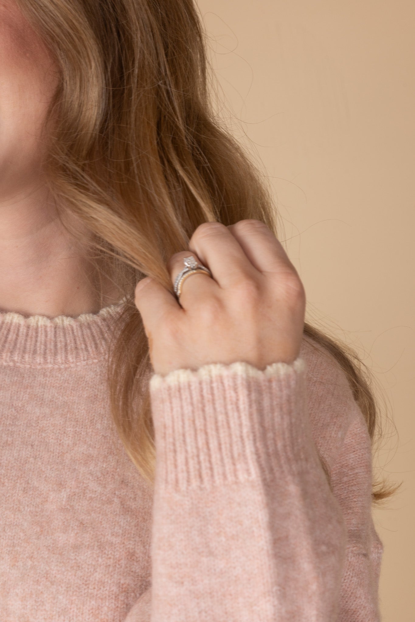 sleeve detail of Women’s pastel pink scalloped knit sweater with cream trim — soft, feminine knit top from ELLX Boutique