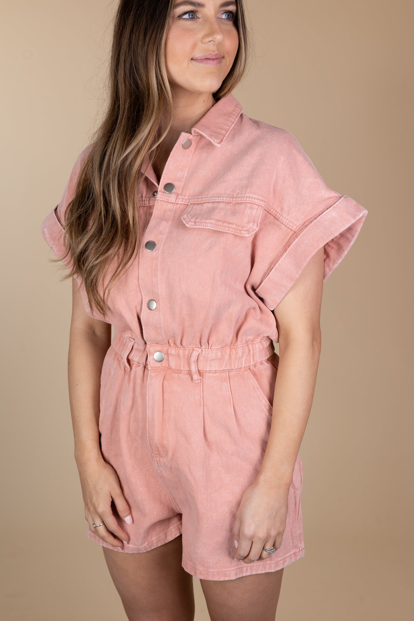 Relaxed Pink Denim Romper with snap button front and zipper closures. Pink color with a relaxed fit. 