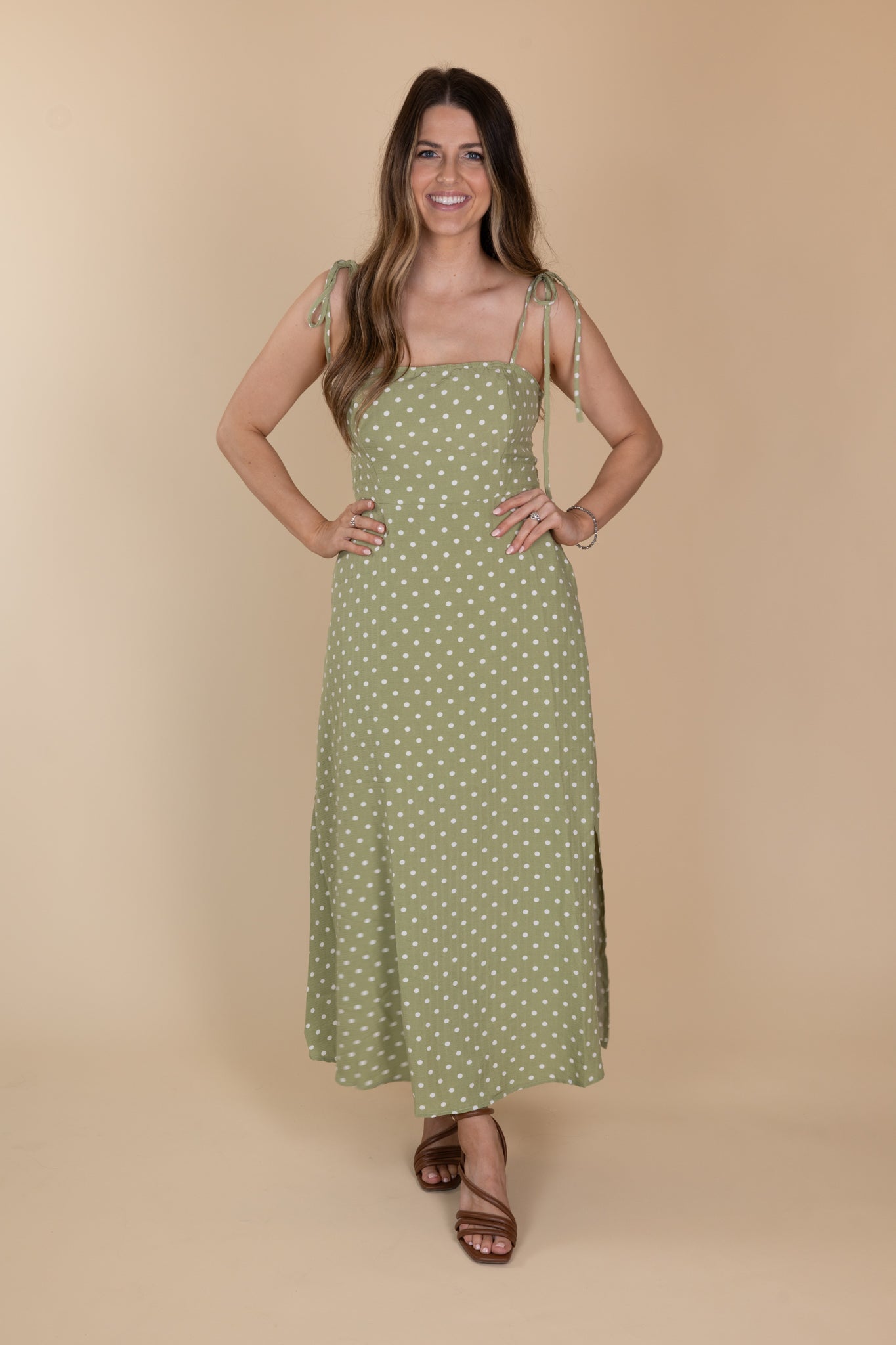 Willow Classic Polka Midi Dress in light green with white polka dots, tie adjustable straps, fitted chest/torso, loose skirt, and midi length. True to size fit.