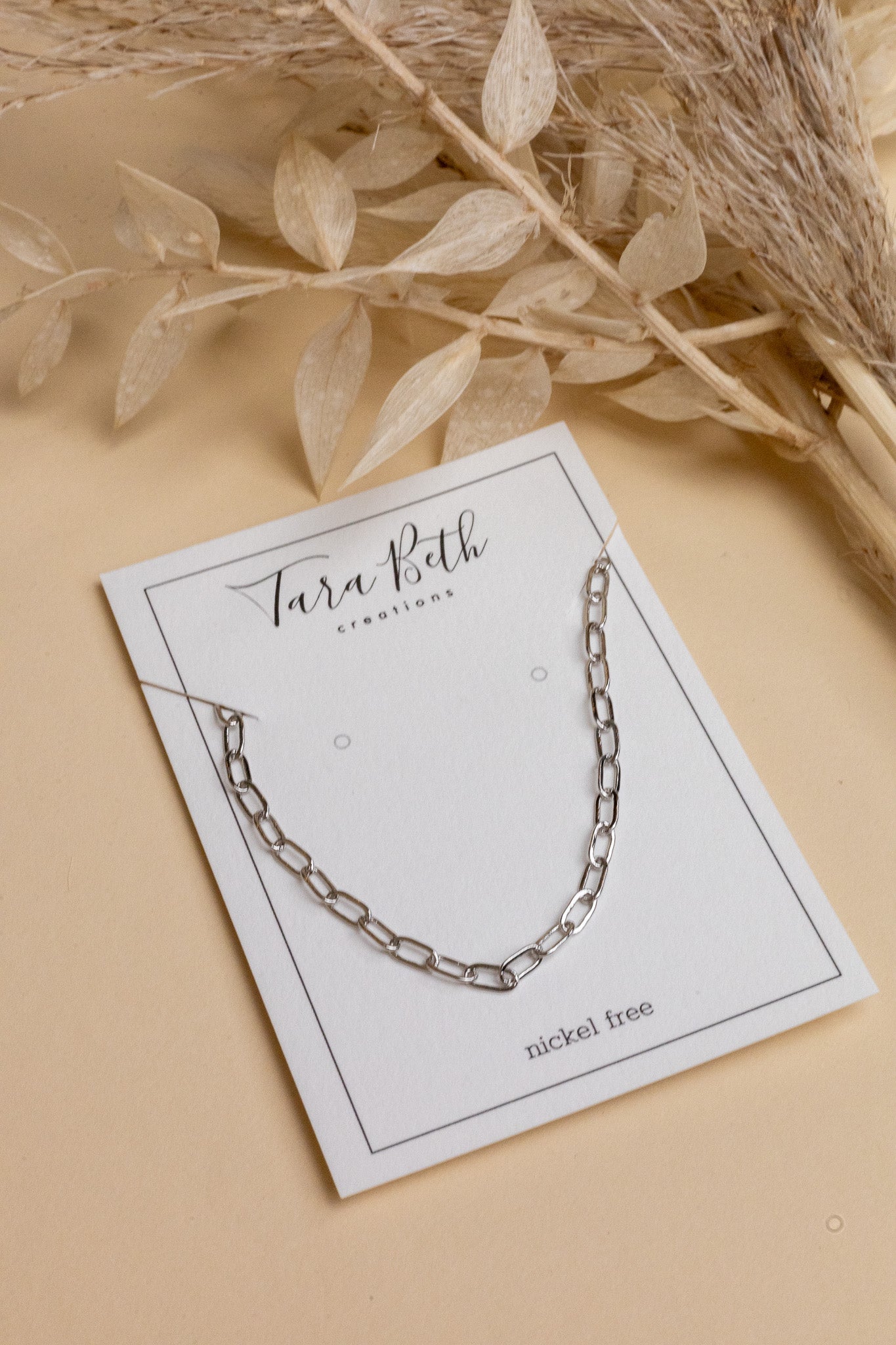 Silver chain link necklace with clasp closure, featuring elegant chain link detailing, nickel-free design.