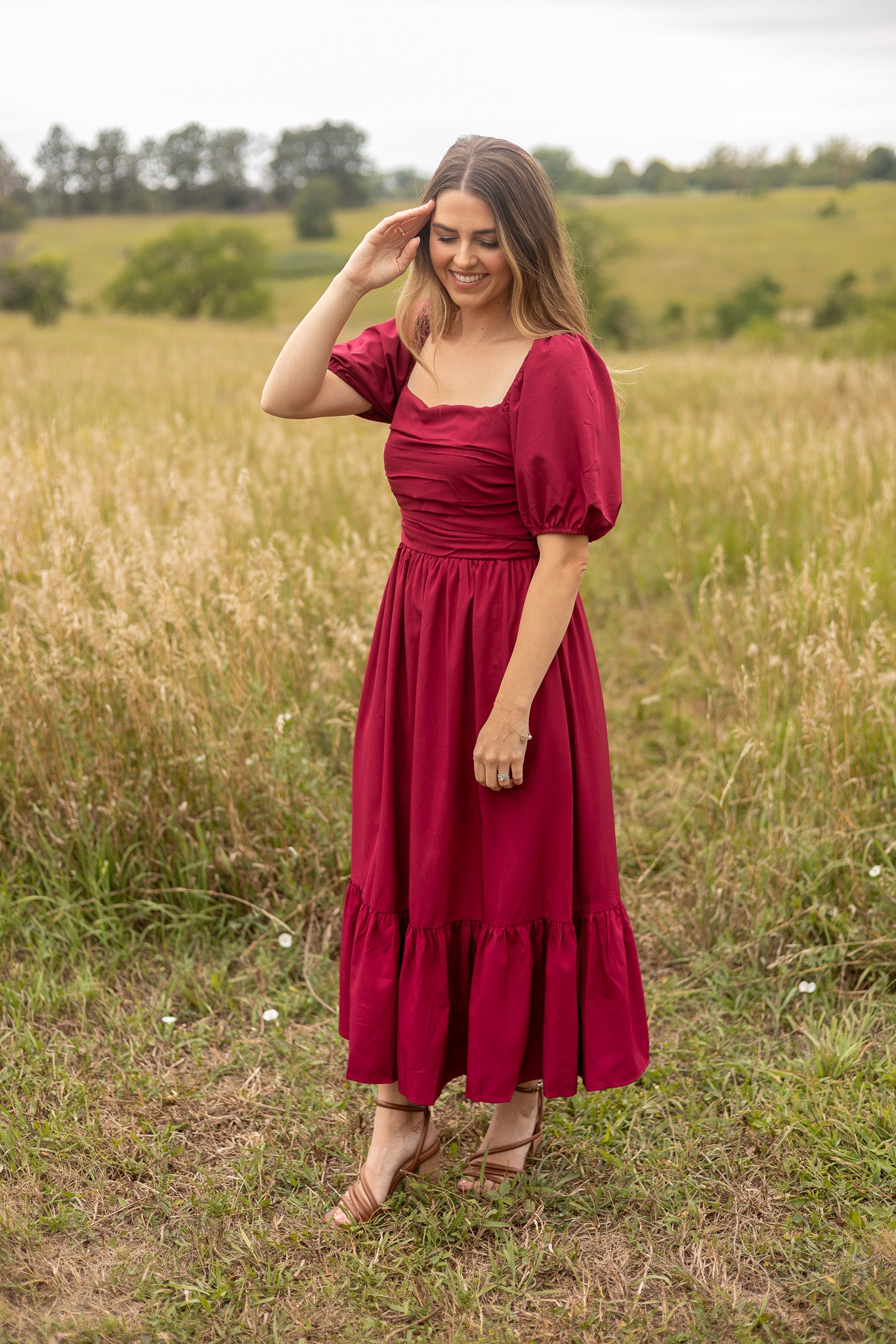 full length view of berry colored puff sleeve dress with ruched bodice and ruffle trim on skirt, maxi length