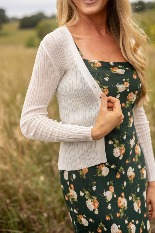 side view of light weight cream ribbed sweater paired with floral slip dress