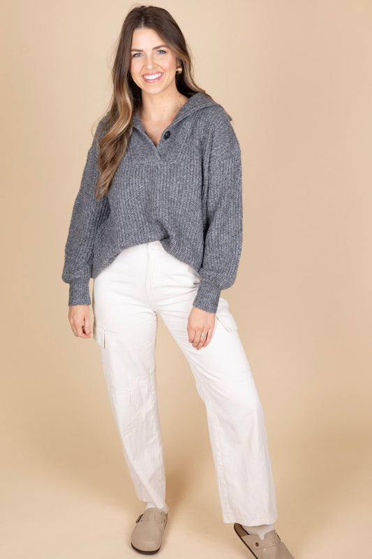 Sawyer Collared Sweater front view with heathered grey fabric and button henley closure with large collar, slightly ribbed. Paired with cream cargo pants and clogs for a comfy look.