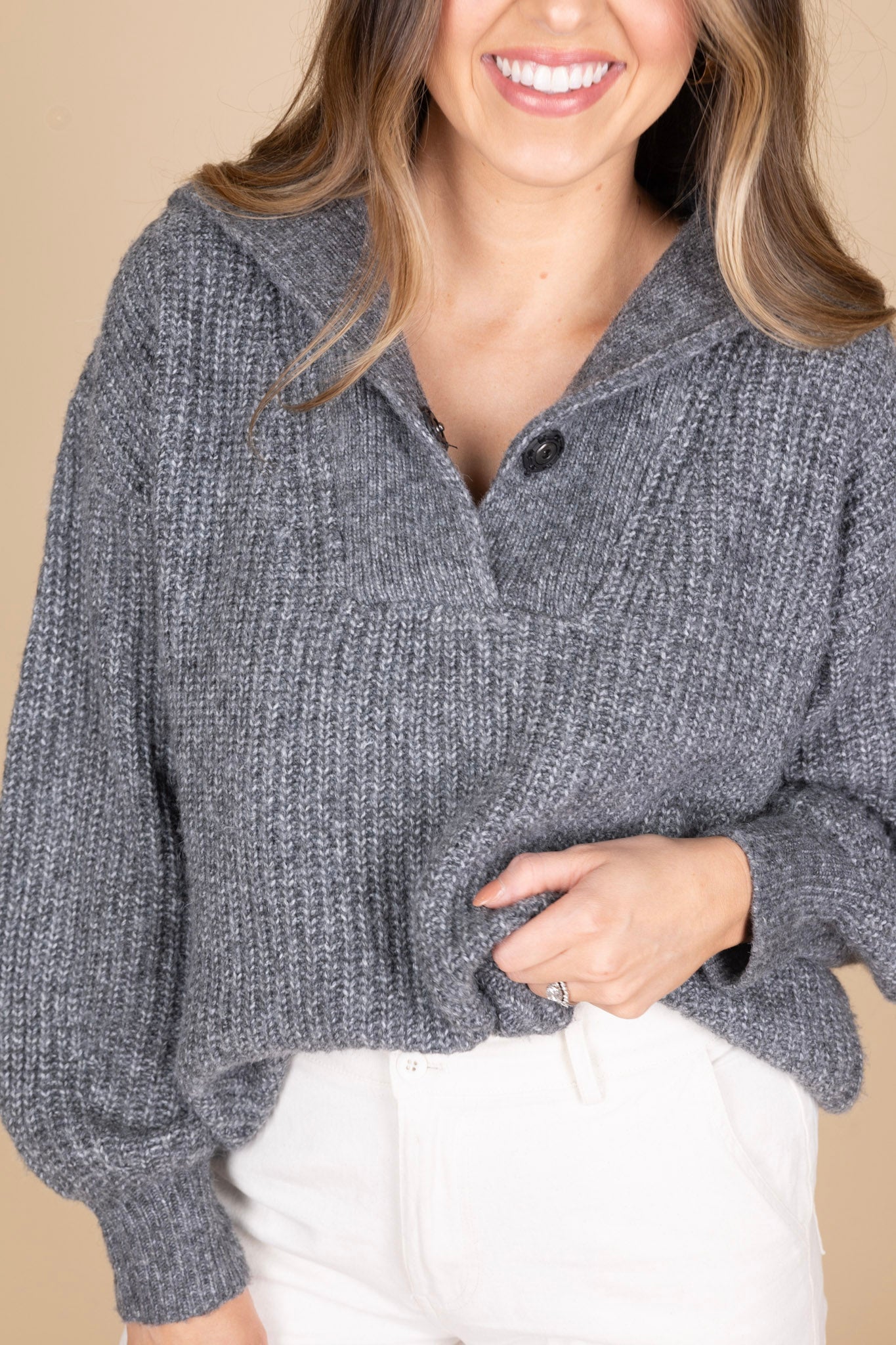 Sawyer Collared Sweater close up view with heathered grey fabric and button henley closure with large collar, slightly ribbed. Paired with cream cargo pants and clogs for a comfy look.