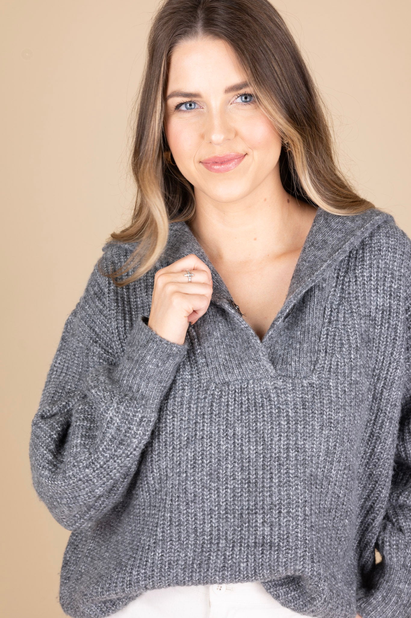 Sawyer Collared Sweater close up view with heathered grey fabric and button henley closure with large collar, slightly ribbed. Paired with cream cargo pants and clogs for a comfy look.