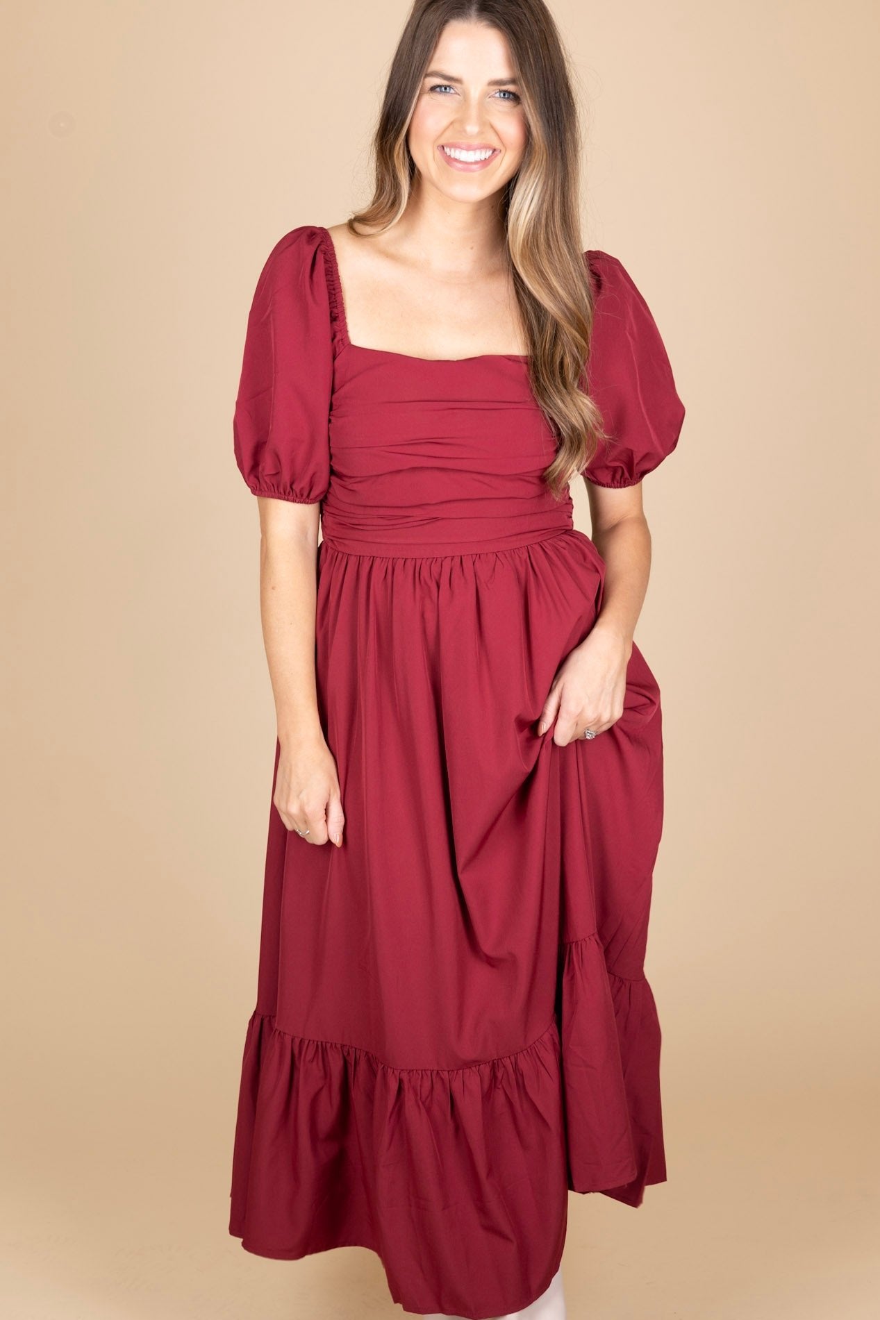 full length view of berry colored puff sleeve dress with ruched bodice and ruffle trim on skirt, maxi length