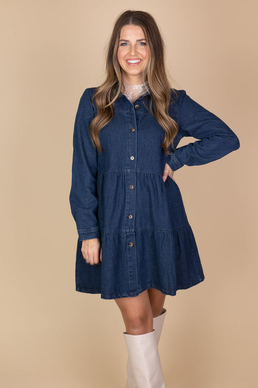Amelia Jean Dress in medium to dark wash with tiered bodice, long sleeves, and button closures for a stylish, versatile look.