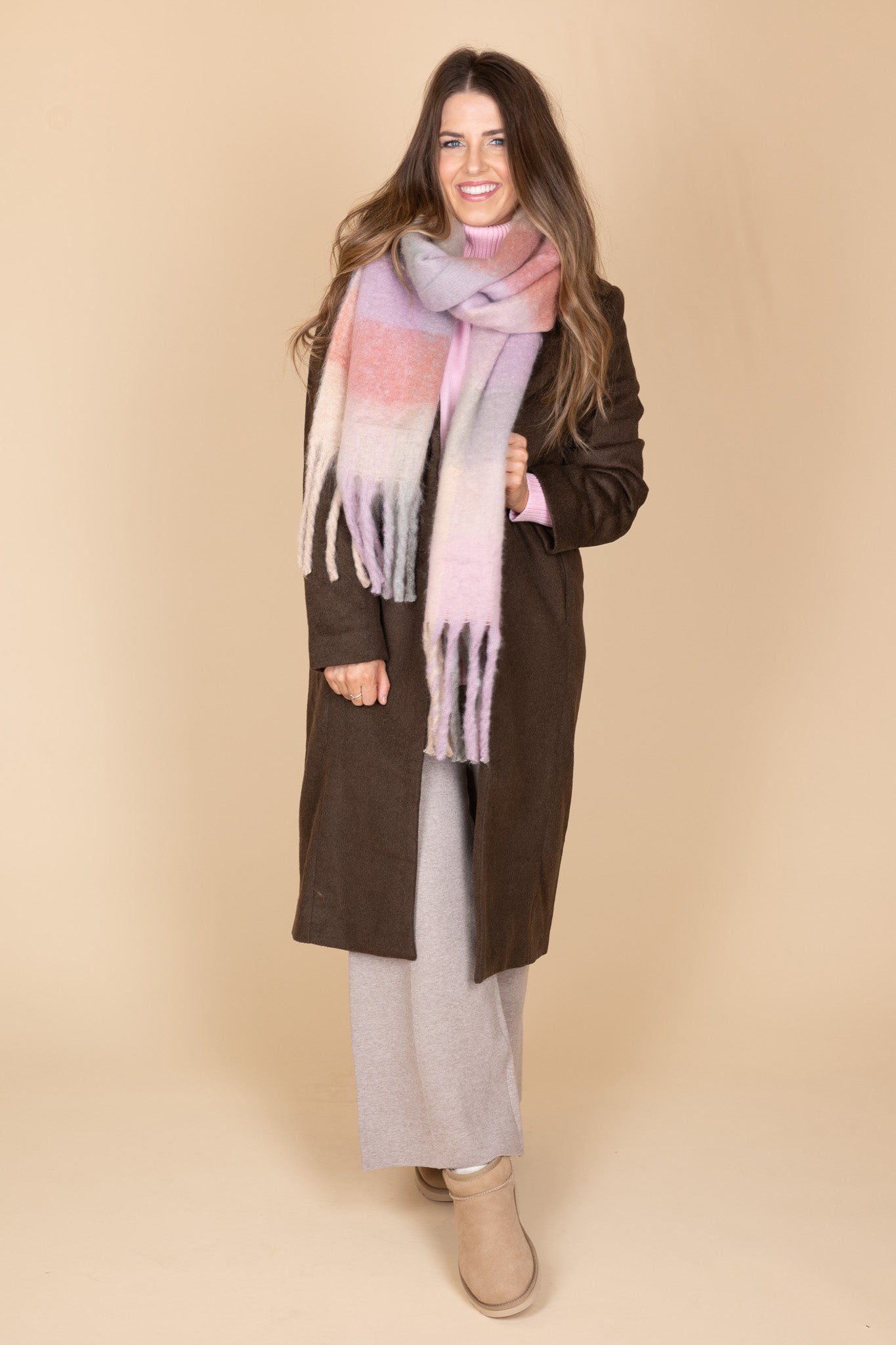 with coat on view of “Ella Ombre Blanket Scarf – a soft and stylish oversized scarf with a beautiful ombre gradient for layering.”

