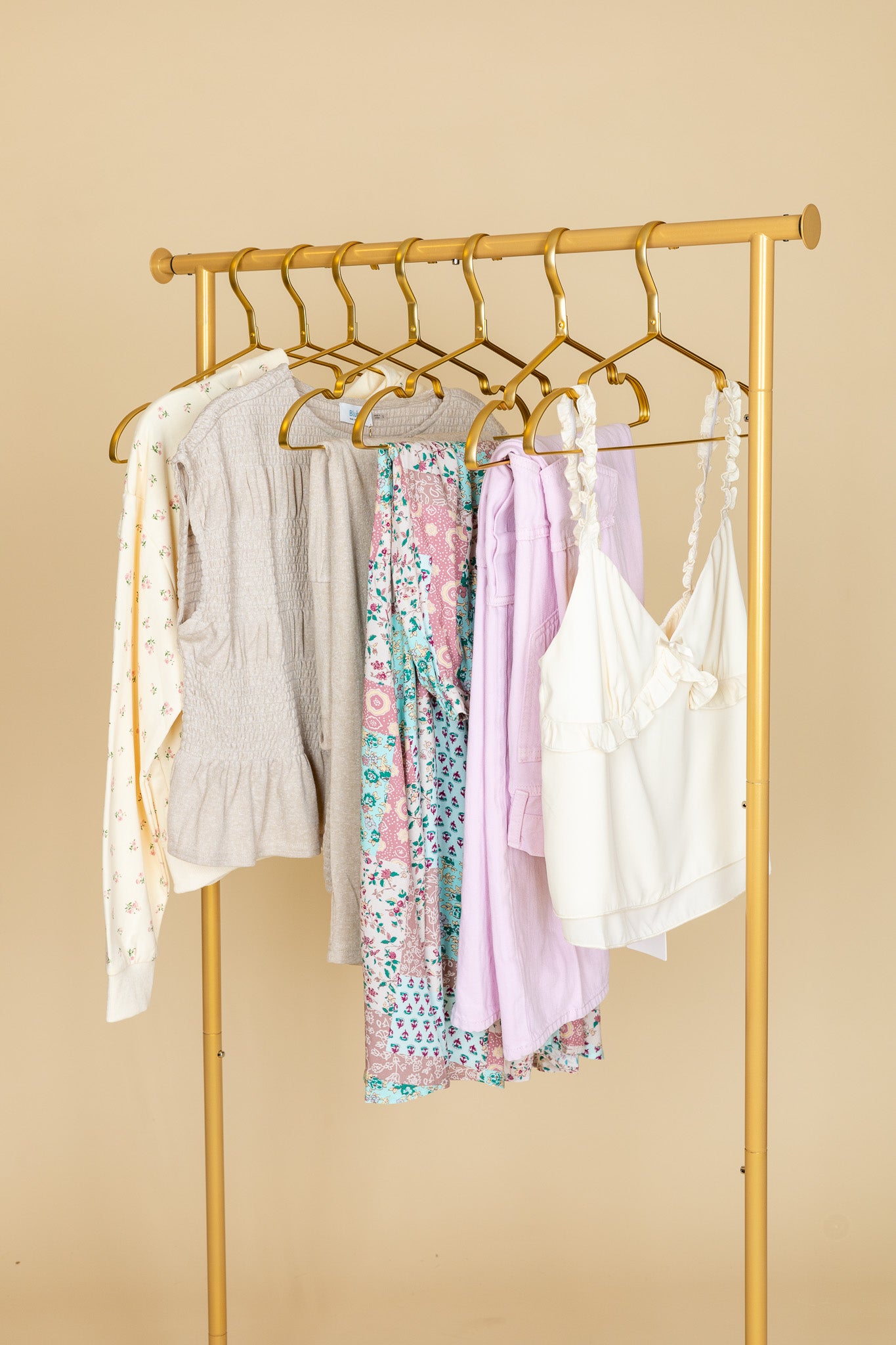 hanging with options Skylar Flutter Top in cream with elastic straps, ruffle and bow detailing, and double lining for a polished finish

