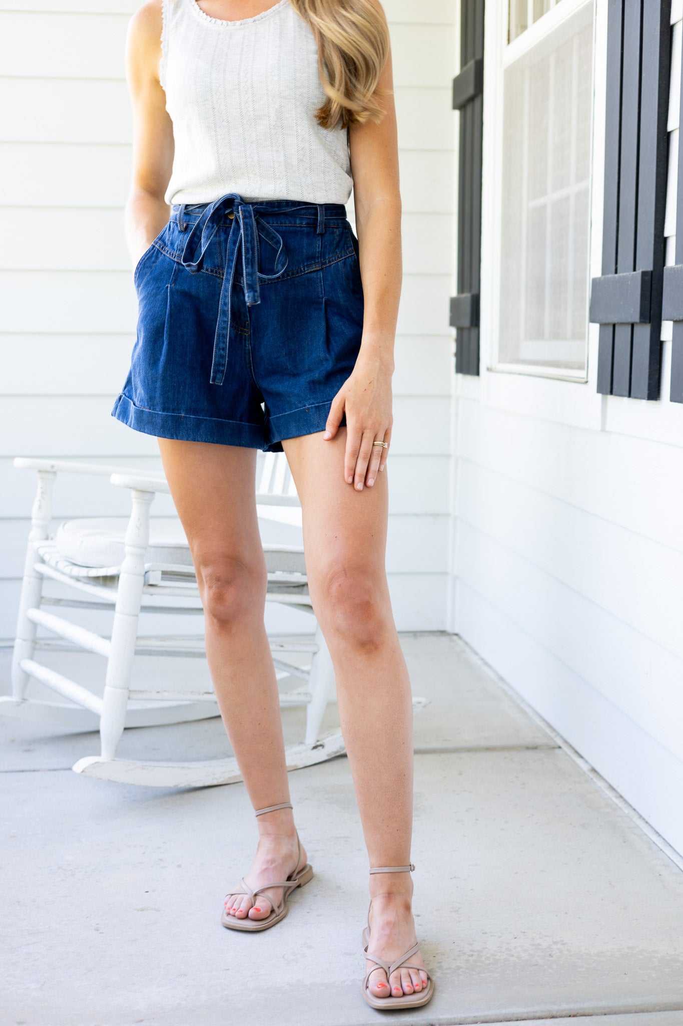Avery Pleated Denim Shorts in dark wash with tie waist, pleated front, elastic waistband, and cuffed hem

