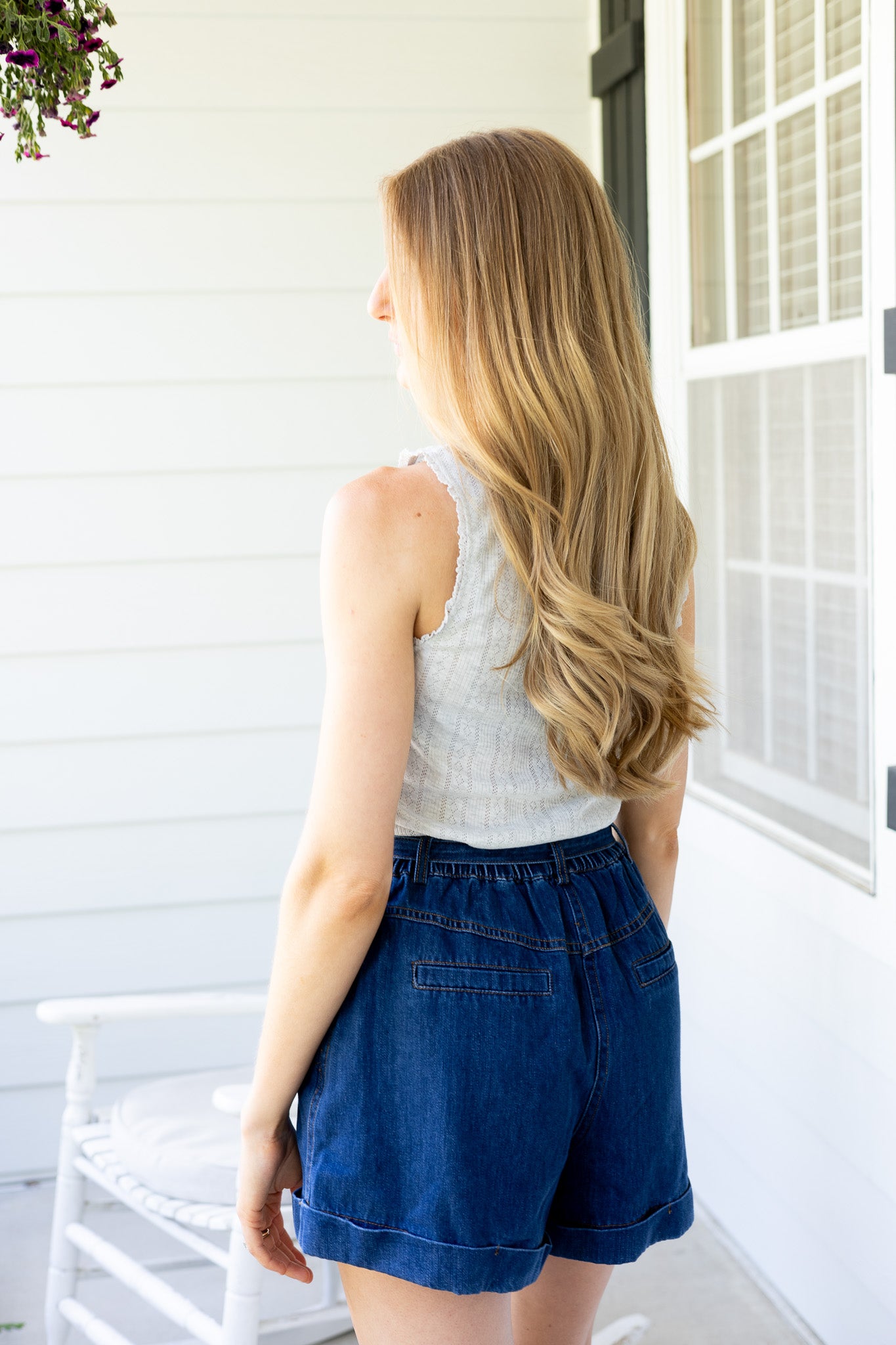 back view Avery Pleated Denim Shorts in dark wash with tie waist, pleated front, elastic waistband, and cuffed hem

