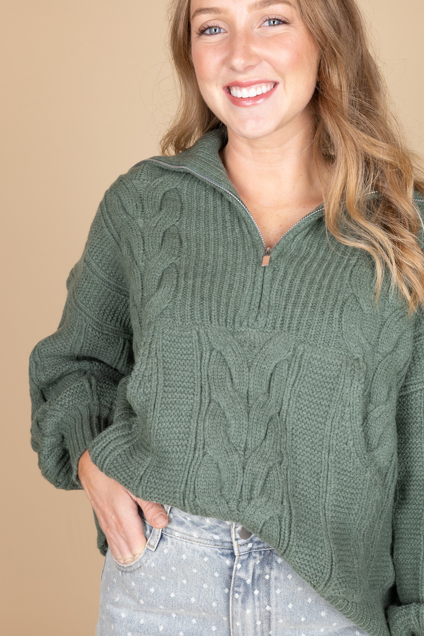 Thick cable knit texture and quarter zip detail on sage green sweater — soft, cozy women’s knitwear