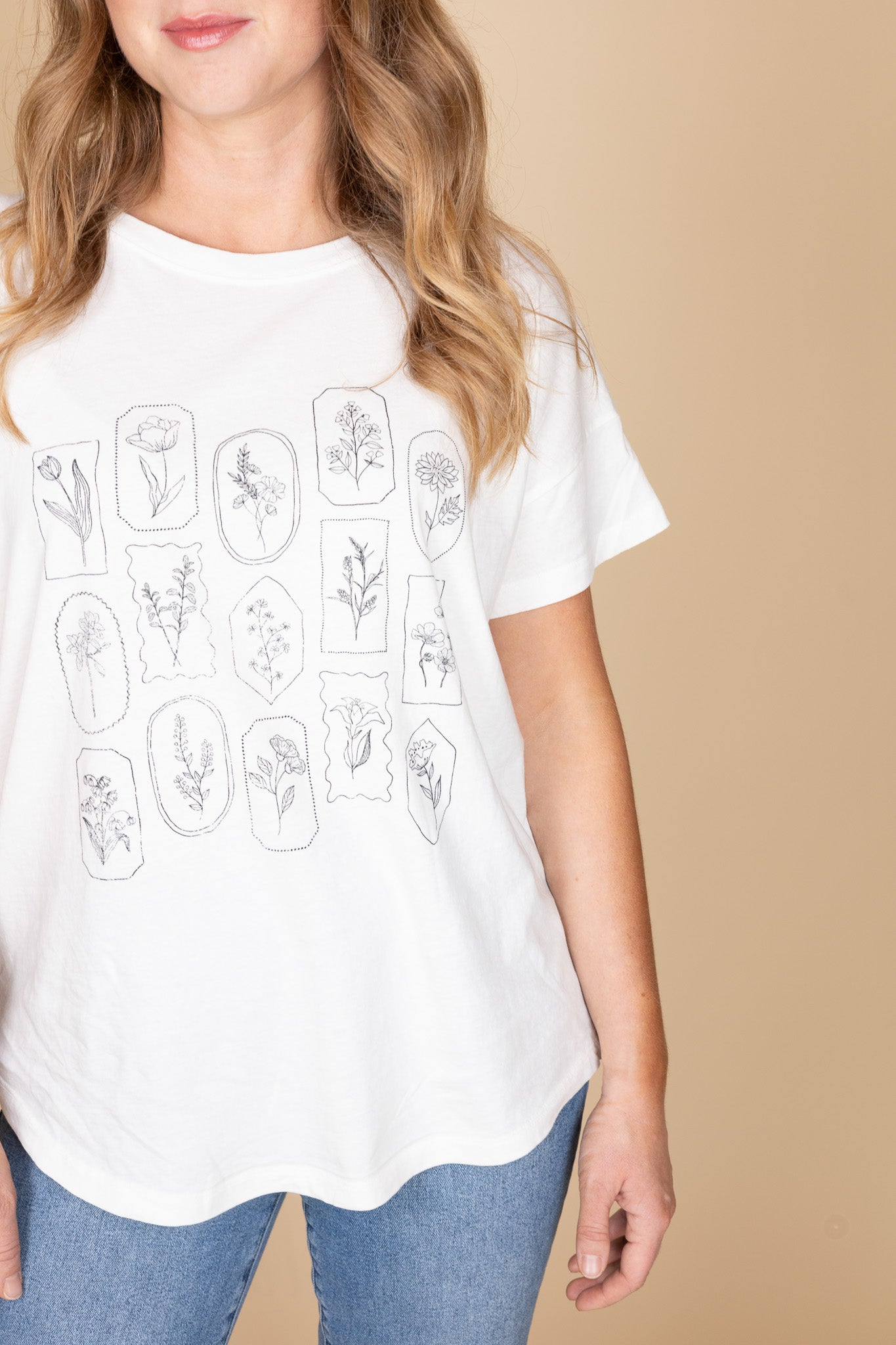 Floral stamped graphic print on white cotton t-shirt — women’s boxy fit tee detail
