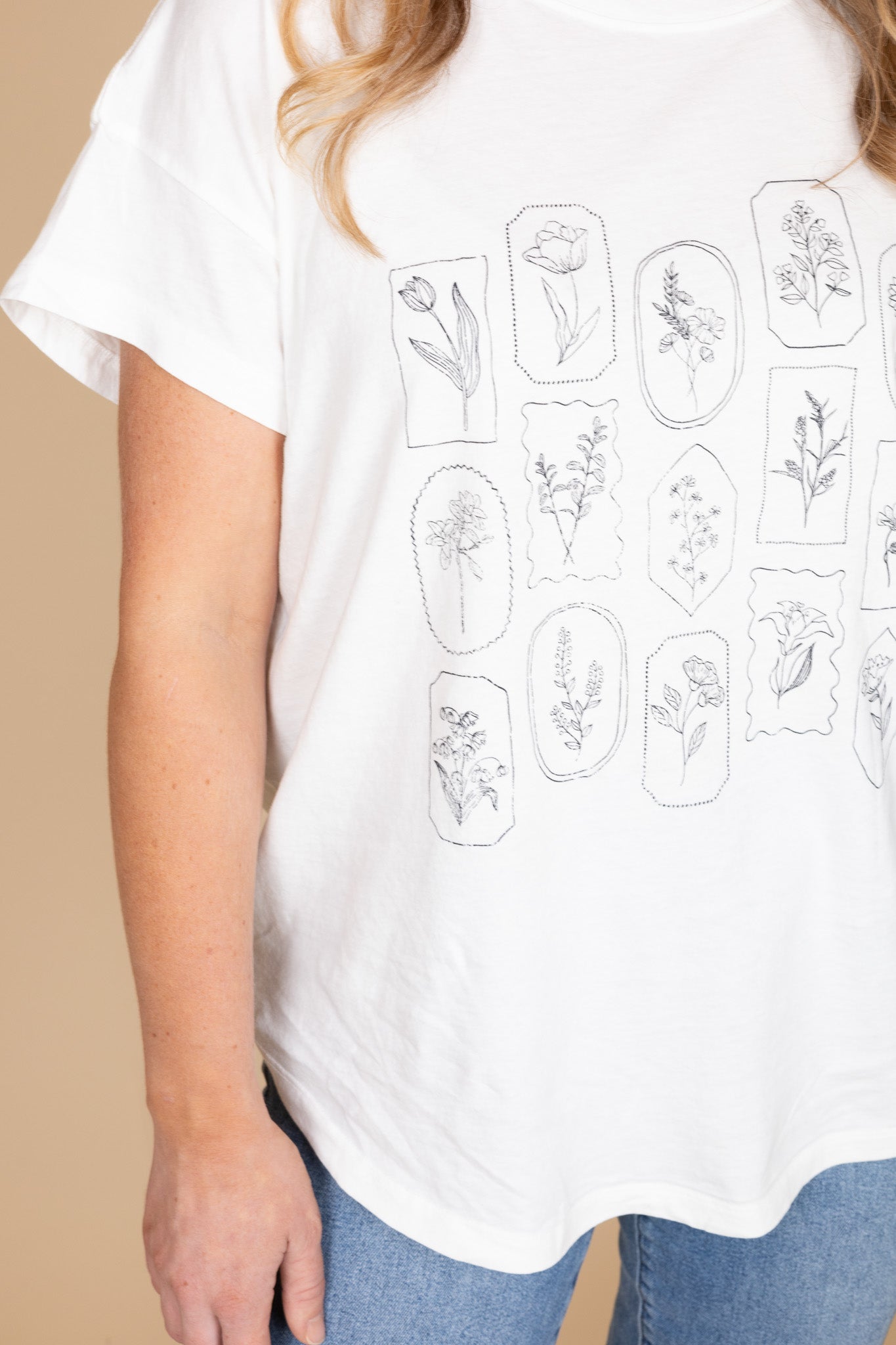 White women’s floral graphic tee with boxy oversized fit — soft, true to size casual top