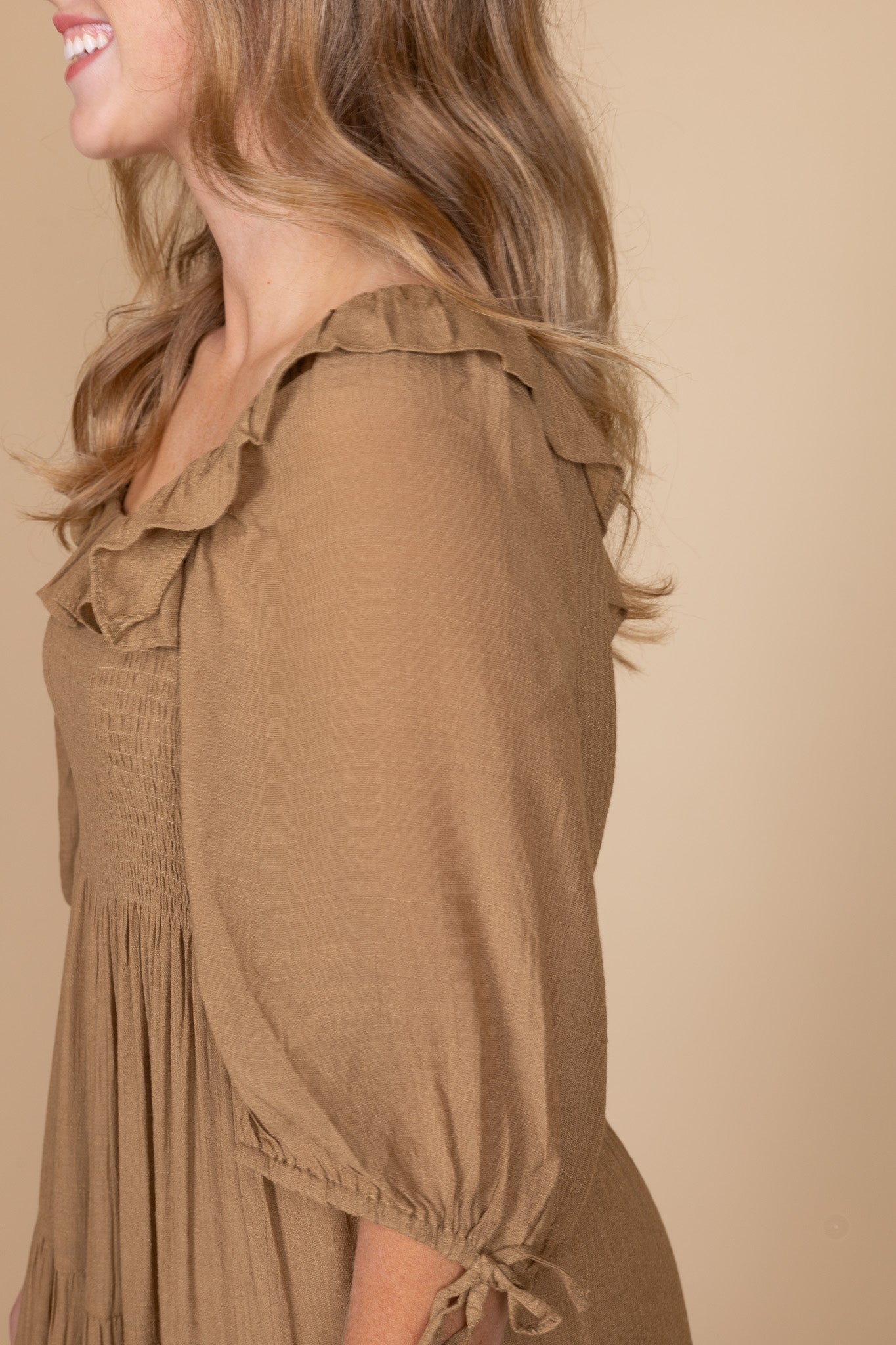 Chestnut brown ruffle tiered skirt and puff sleeve with bow detail — women’s smocked midi dress close-up