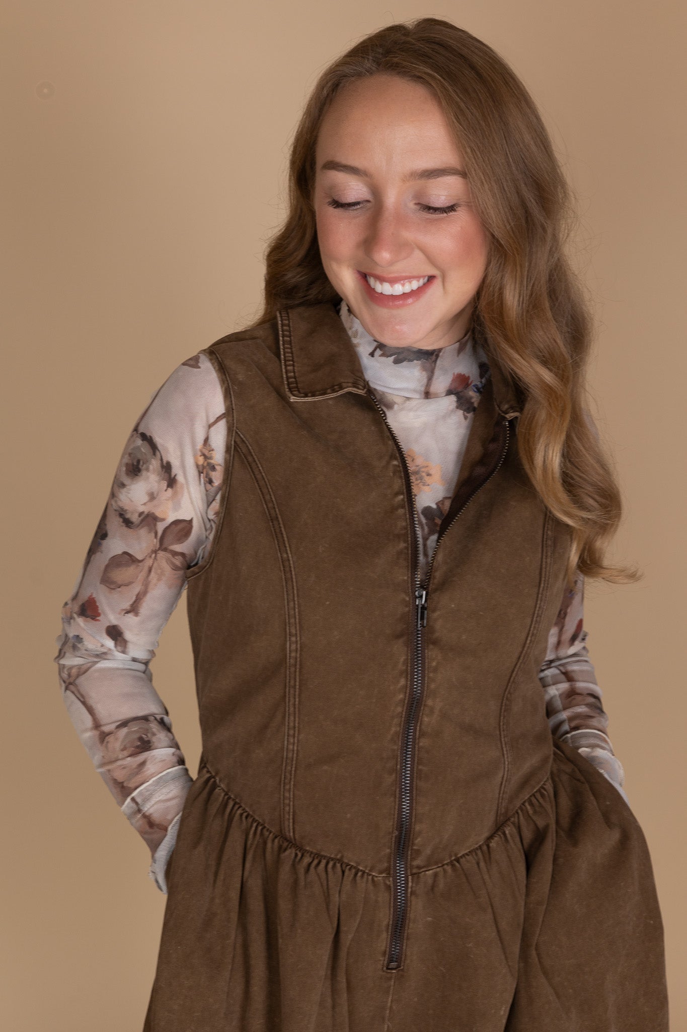 Front zipper and V-hem waist detail on women’s twill denim mini dress — structured fabric close-up