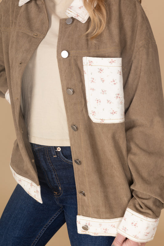 Brown corduroy fabric with pink and cream floral trim and functional buttons — soft texture women’s jacket detail